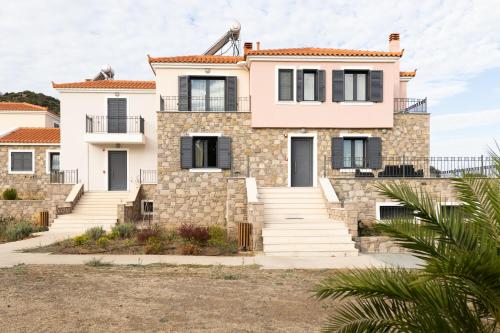 a house on the beach with stairs at Lampetos Houses Molyvos in Mithymna