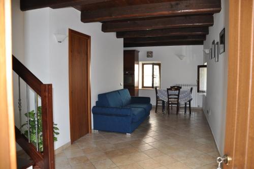 a living room with a blue couch and a table at Agriturismo Casavecchia in Abetito