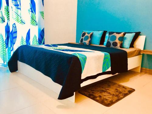 a bedroom with a bed with a blue and white at Sugar Reef West Coast in Flic-en-Flac