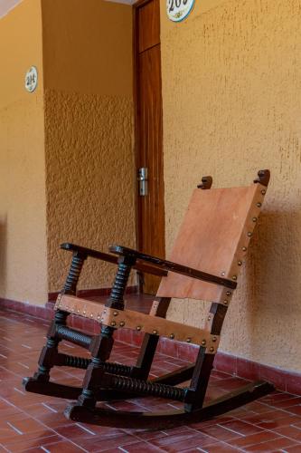 a wooden bench sitting in front of a wall at Hotel Margaritas in Mazatlán