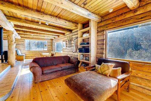 a living room with a leather couch and a chair at Ridgerunner Cabin in Taos Ski Valley