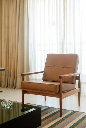 a brown leather couch in a living room at Hotel Luzeiros São Luis in São Luís