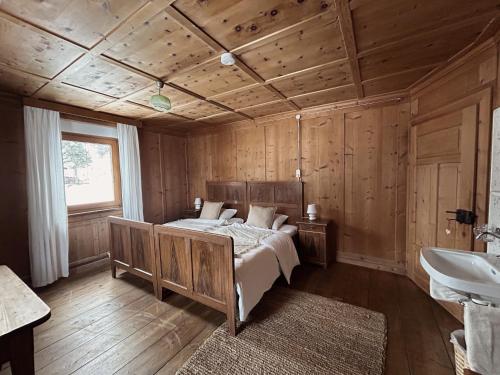 a bedroom with a bed and a sink in a room at Ferienhaus Alpenglück in Wenns