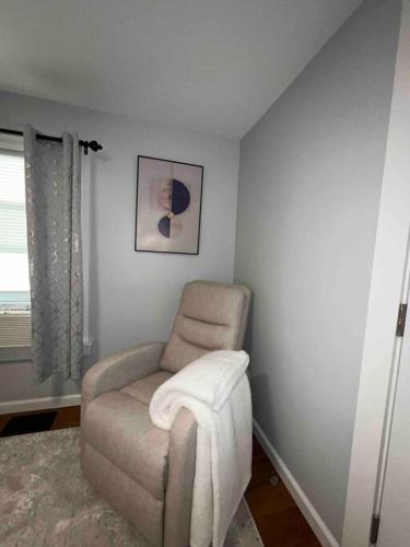 a living room with a chair and a window at Two Bedroom Apartment on Forestville Bristol in Bristol