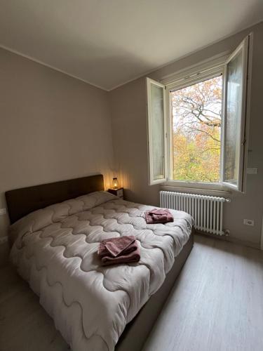 a bedroom with a large bed with two towels on it at Maison del Ducato Suite Correggio in Parma