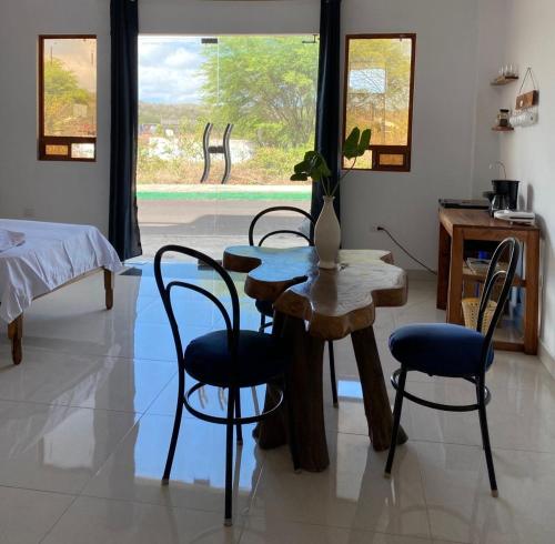 a living room with a table and chairs and a bed at habitación cerca a playa man in San Cristóbal