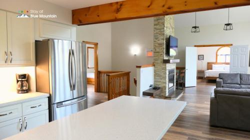 a kitchen and living room with a stainless steel refrigerator at Summit Ridge 3 in Blue Mountains