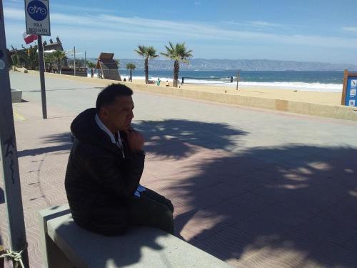 a man sitting on a bench next to the beach at Buda de uco in Tunuyán