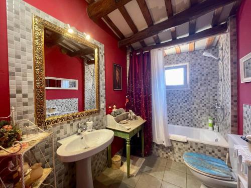 a bathroom with a sink and a tub and a toilet at La Morada Del Unicornio in Calonge