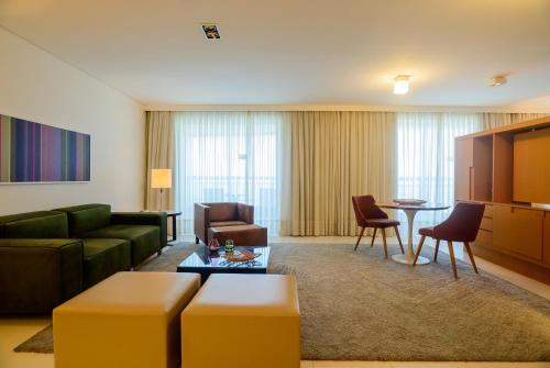 a living room with a couch and a table at Hotel Luzeiros São Luis in São Luís