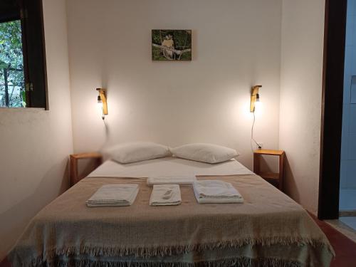 Ένα ή περισσότερα κρεβάτια σε δωμάτιο στο Aruá Observação de aves e natureza