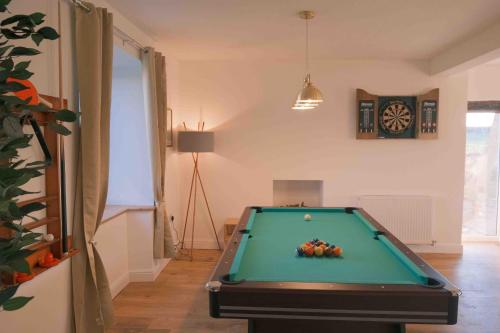 a room with a pool table and a clock at Hycemoorside House in Millom