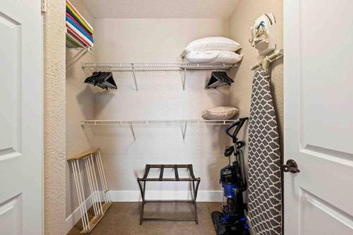 a walk in closet with a door and a tie at Modern La Quinta Condo Old Town, Pool, Golf in La Quinta