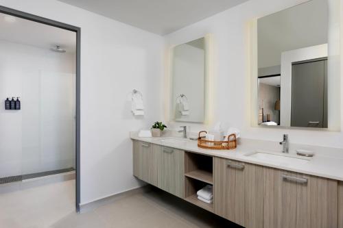 a bathroom with a sink and a mirror at Casa Costera, Isla Verde Beach, Apartments by Marriott Bonvoy in San Juan