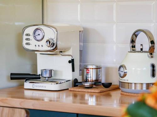 a kitchen counter with a coffee maker and a mixer at vaya_living in Ktistádes