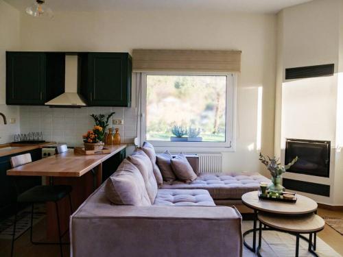 a living room with a large couch in a kitchen at vaya_living in Ktistádes