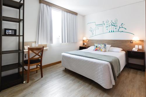 Ένα ή περισσότερα κρεβάτια σε δωμάτιο στο Garibaldi Business Hotel