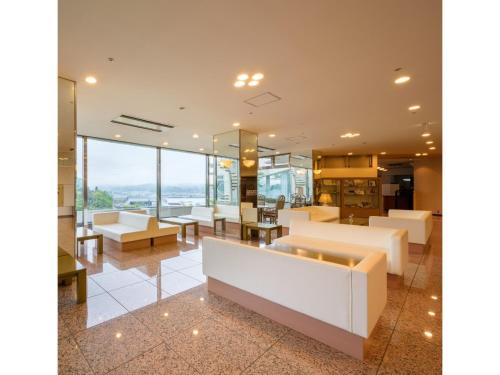 a lobby with white furniture and glass windows at Kesennuma Plaza Hotel - Vacation STAY 15381v in Kesennuma