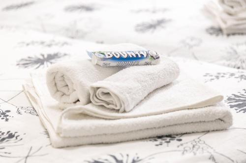 a tube of toothpaste sitting on top of towels at Maris in Osijek