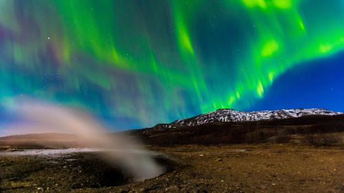 an image of the aurora dancing in the sky at Litli Geysir Hotel in Haukadalur