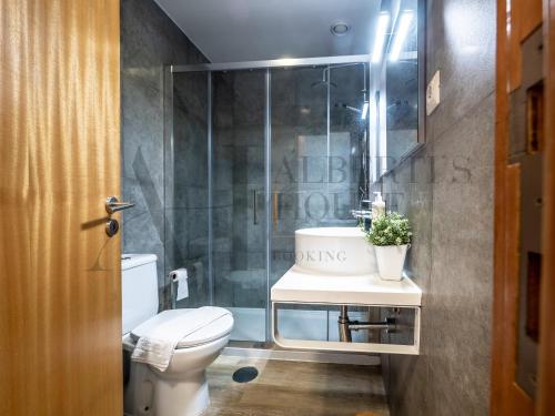 a bathroom with a toilet and a sink and a shower at Alberti's House Oporto Central Apartment in Porto