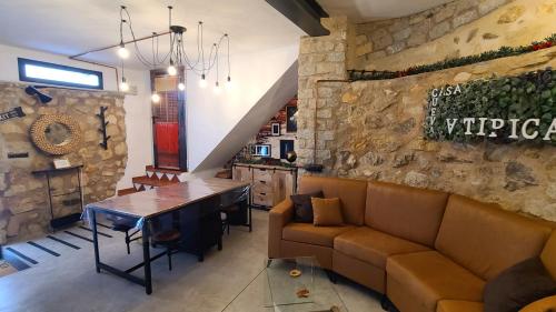 a living room with a couch and a table at CASA CUEVA A-TIPICA in Pegalajar