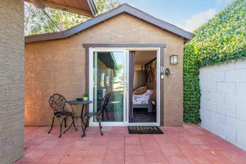 a patio with two chairs and a table and a bedroom at Your Tiny Downtown Home with Backyard Unit D in Phoenix
