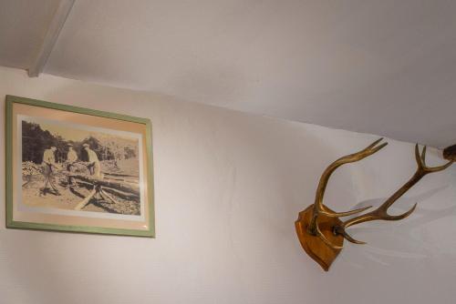 a antler hanging on a wall next to a picture at Les Bucherons in Awenne