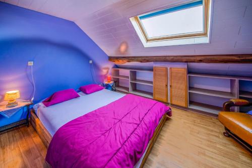 a bedroom with a bed with pink sheets and a window at Les Bucherons in Awenne