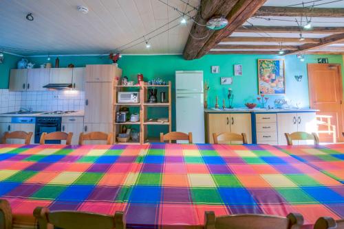 a kitchen with a table with a colorful blanket on it at Les Bucherons in Awenne