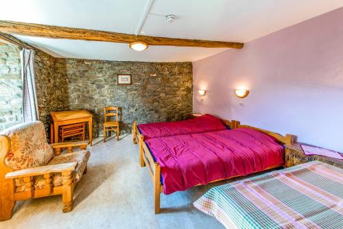 AwenneにあるLes Bucheronsのベッドルーム(赤いベッド1台、椅子付)
