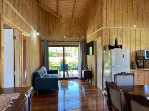 a living room with a couch and a refrigerator at Comodidad y hermosa vista volcán in Melipeuco