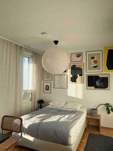 a bedroom with a bed and a pendant light at Cozy Top-Floor Studio in Turku - Near City Center in Turku