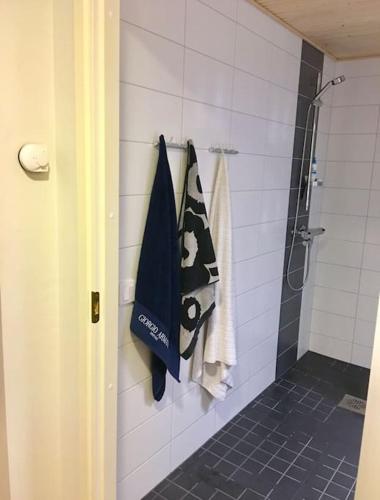 a bathroom with a shower and a towel at Cozy Top-Floor Studio in Turku - Near City Center in Turku