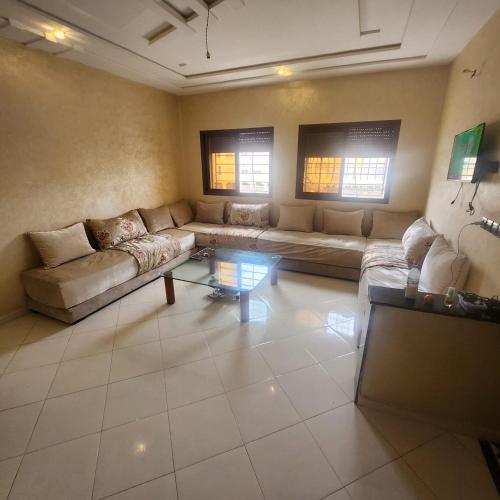 uma sala de estar com um sofá e uma mesa em B 1 apartment em Fez