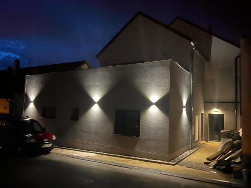 a building with lights on the side of it at night at Restaurace - penzion Bavorský dvůr in Sezemice