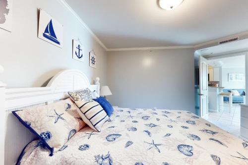 a bedroom with a bed with a blue and white comforter at Makai 108 in Ocean City