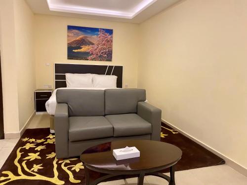 a living room with a couch and a bed at City Stay Residences - Serviced Apartments DIP in Dubai