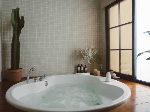 a large bath tub with a cactus in a bathroom at Villa Ramimedi - Vistas al Mar in Puerto del Carmen