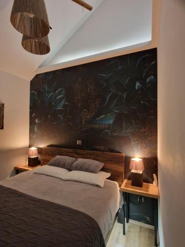 a bedroom with a large bed with two night stands at Aura Lux Holiday Home with Pool in Lopatinec