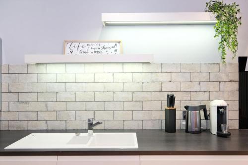 a kitchen counter top with a sink and a counter sidx sidx at The Northern House in Aberdeen