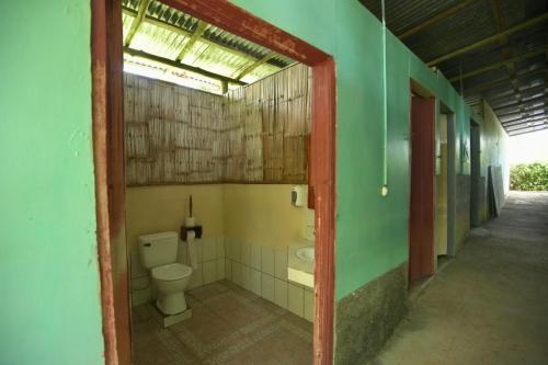 an empty bathroom with a toilet in a building at Cabinas vista isla del caño corcovado in Drake