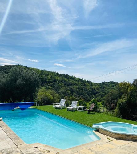 - une piscine avec des chaises et une vue sur la montagne dans l'établissement Domaine de Gourgounet Gite de groupe 25 couchages avec piscine privative, à Villefloure