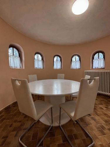 a dining room with a white table and chairs at Omega Apartman in Miskolc
