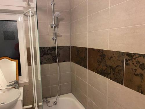 a bathroom with a shower and a toilet and a sink at 2 bedroom flat Camberwell grove in London