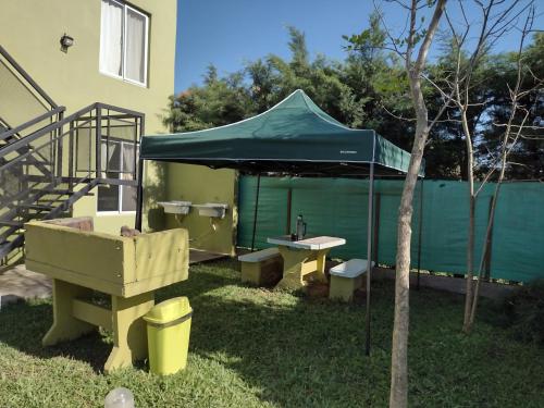 a blue tent with a sink and a table in a yard at Sol de Belen in San José
