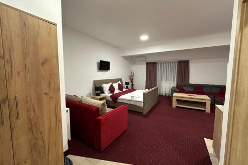 a room with a living room with a couch and a bed at Hotel Muška voda in Kladanj