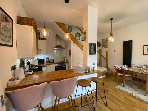 a kitchen with a counter and chairs in a room at Longsands Hideaway in Tynemouth