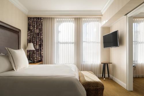 a hotel room with a bed and a flat screen tv at The Manhattan Club in New York