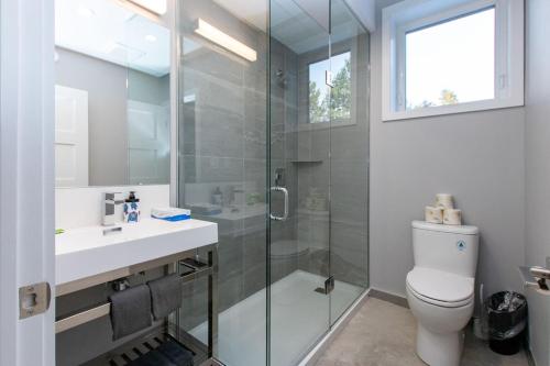 a bathroom with a shower and a toilet and a sink at 107 Birchview Trail in Blue Mountains